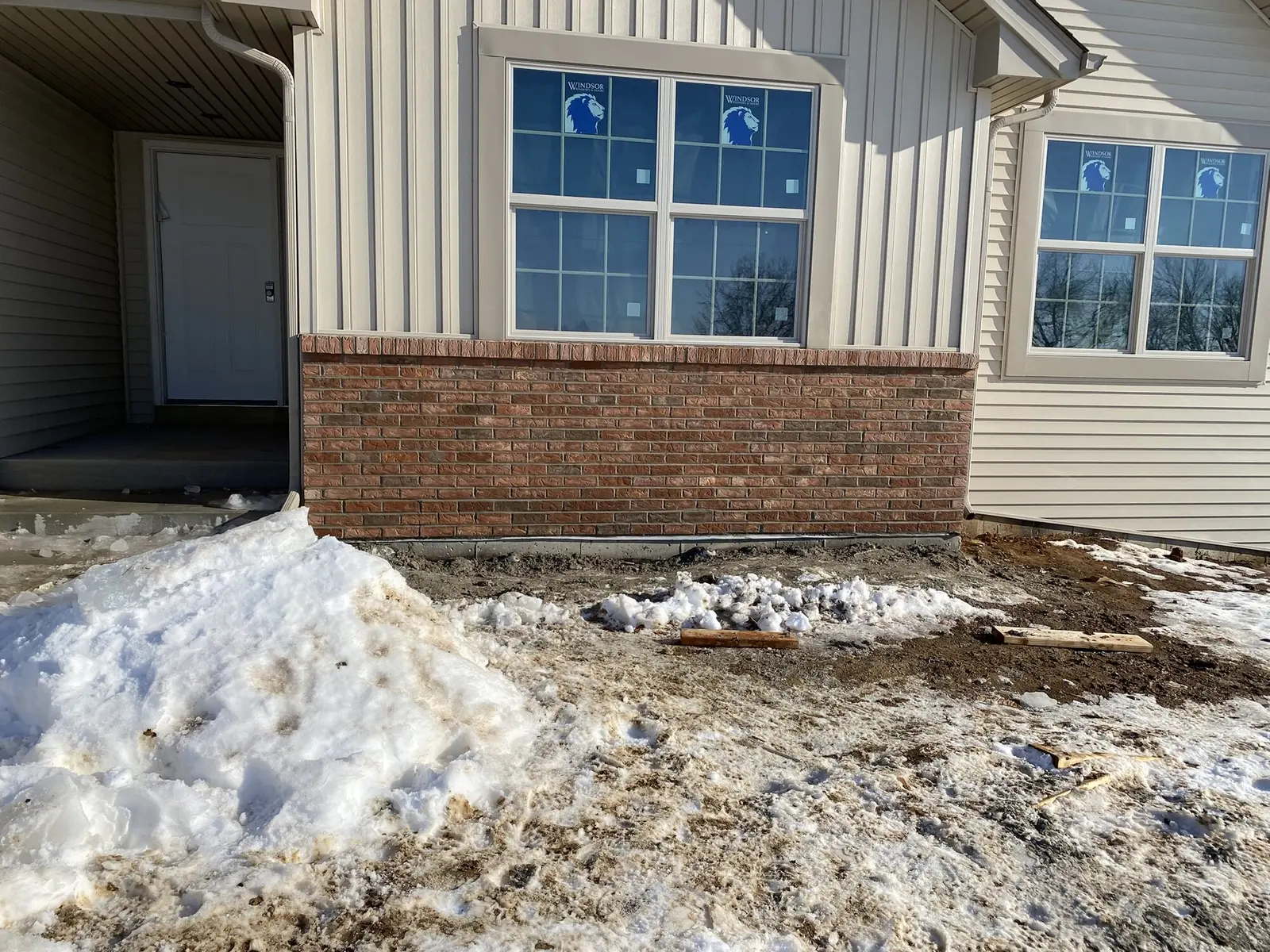 Brick wainscot with windows on custom home exterior