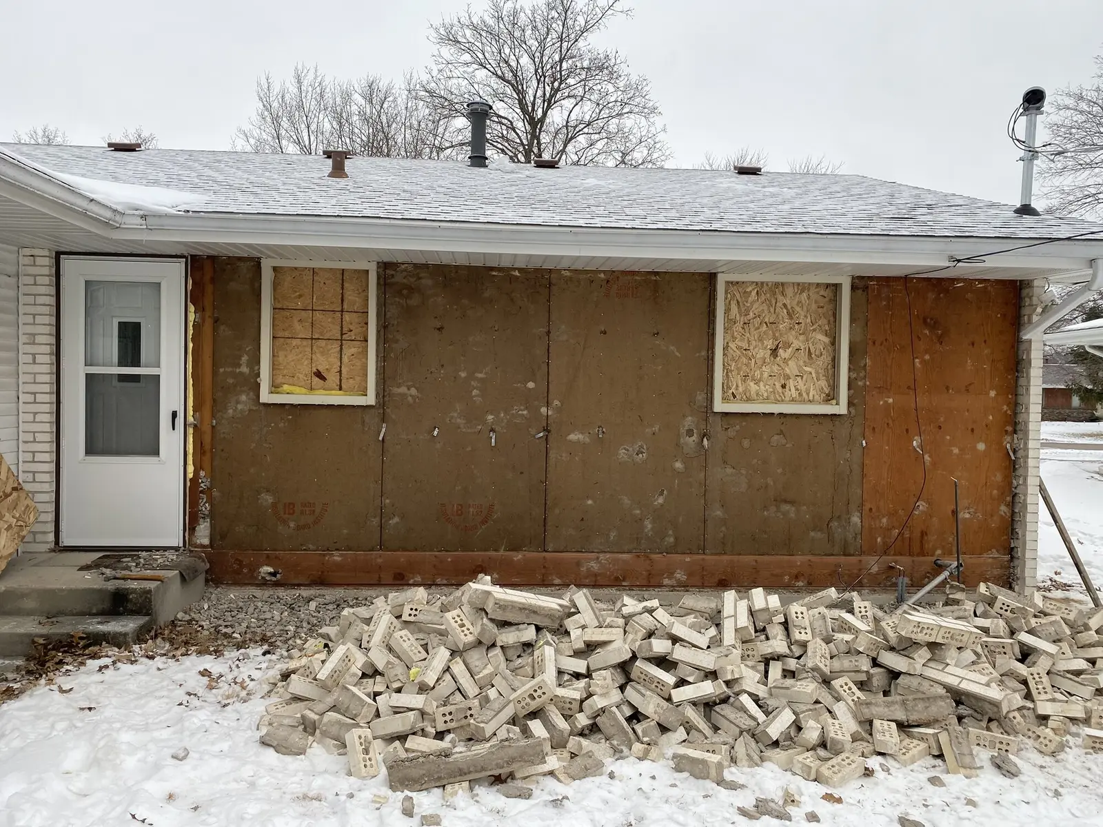 Exterior wall after full brick removal, ready for new material
