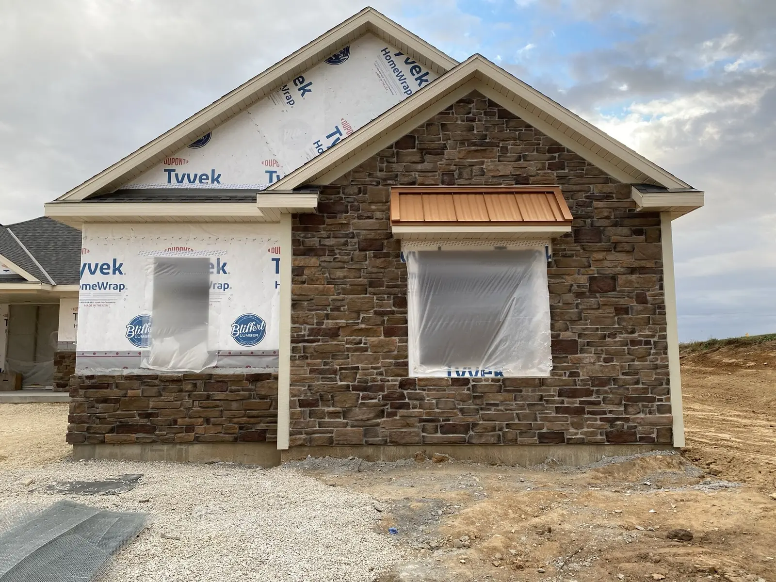 Stone veneer gable and window surrounds on custom home