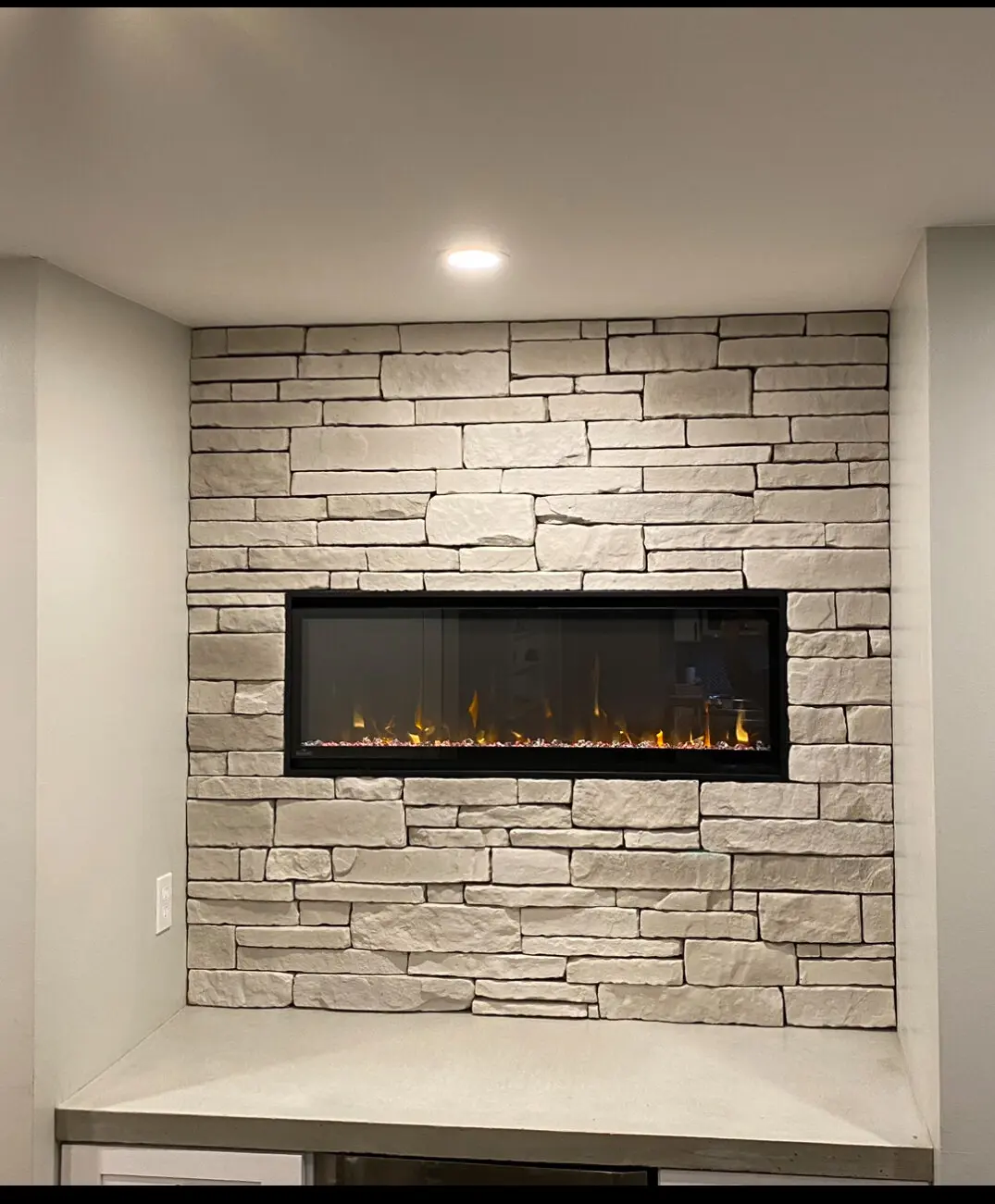 Close-up of interior stone veneer fireplace surround showing tight joint craftsmanship